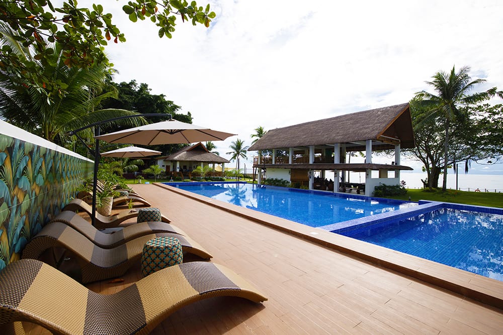 Pool surrounded by tropical landscaping